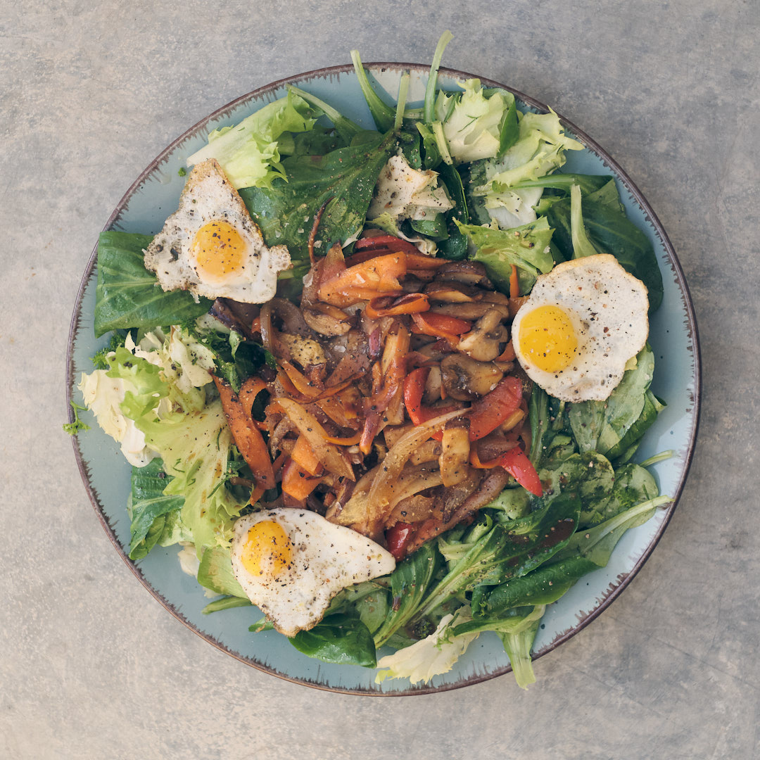 Winter salad with sautéed vegetables and quail eggs